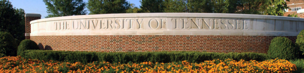 UT Institute for Agriculture entrance sign and orange flowers